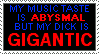 A stamp that says 'My music taste is <em>abysmal</em> but my dick is <em>gigantic</em>.